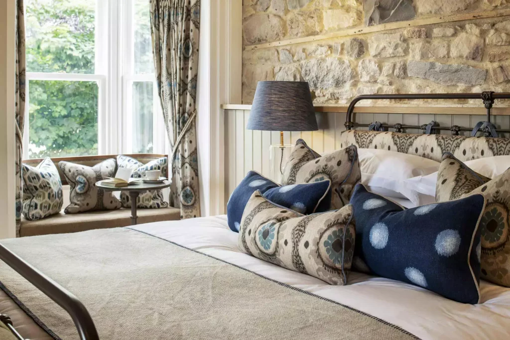 Bedroom with a stone wall and a bedside tabletop