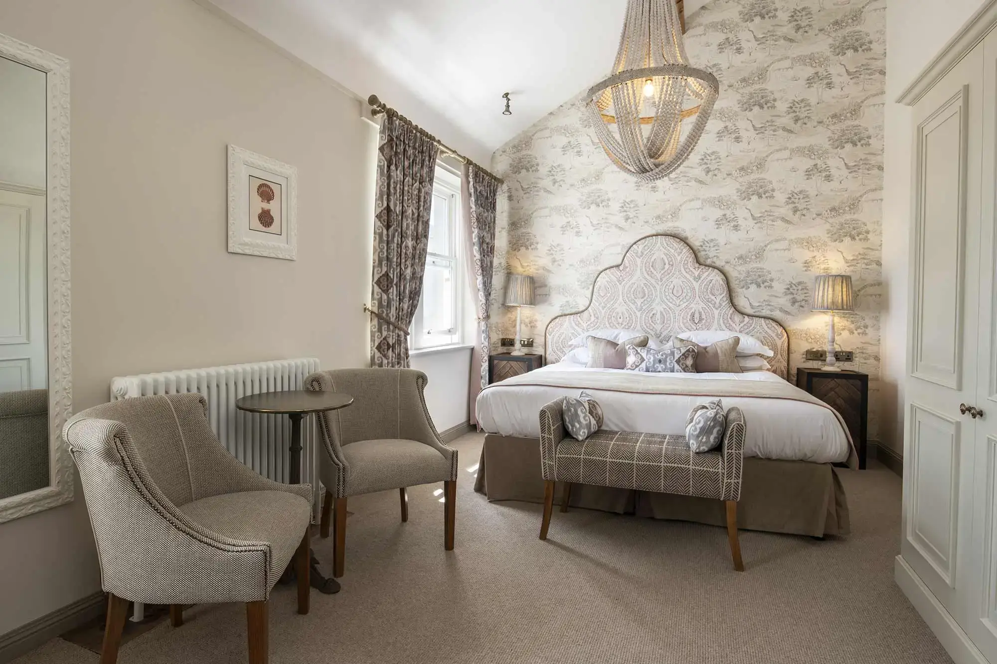 Bedroom with two chairs next to a tabletop