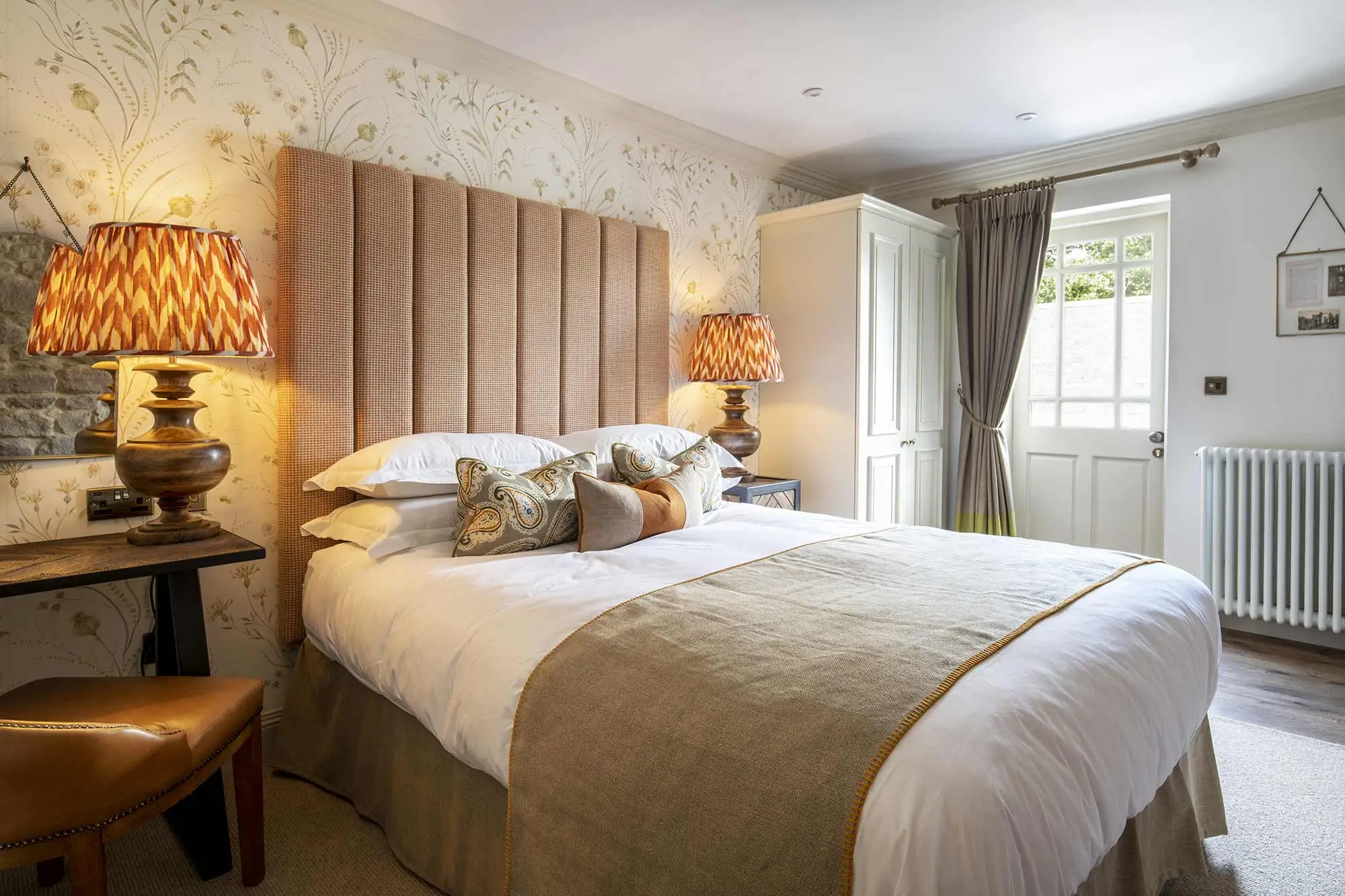 Bedroom with a double bed and a brown leather chair