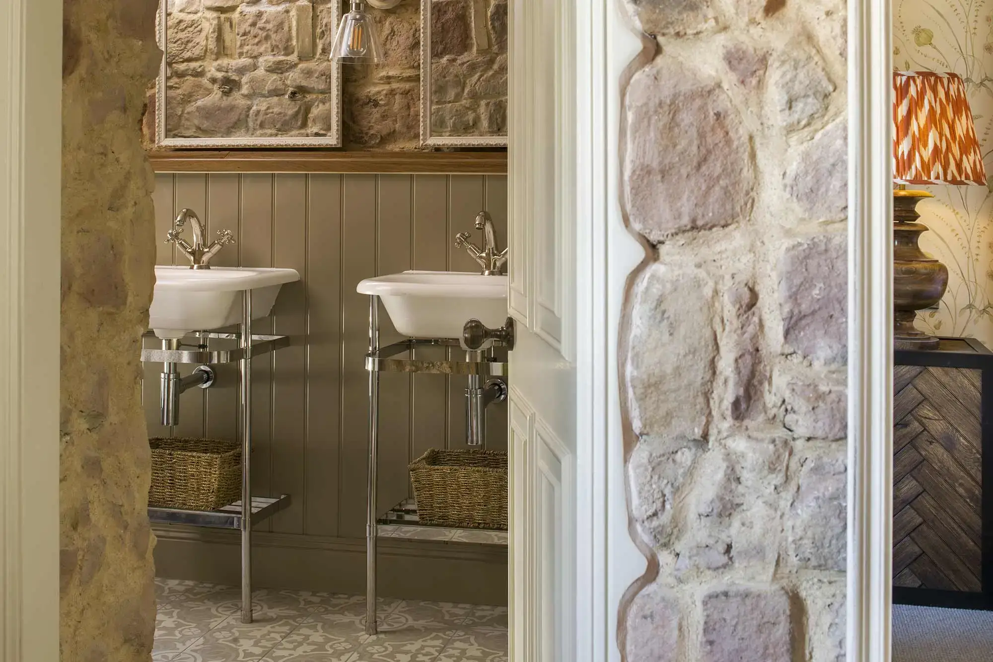 Room with door open revealing two sinks