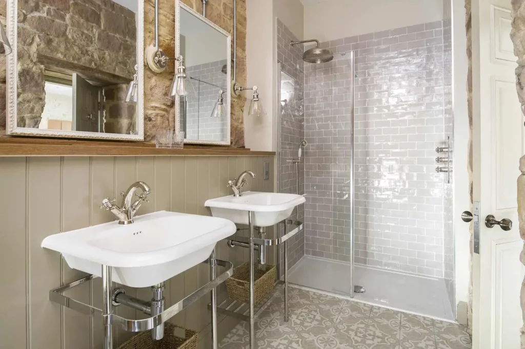 Bathroom with two sinks and a shower