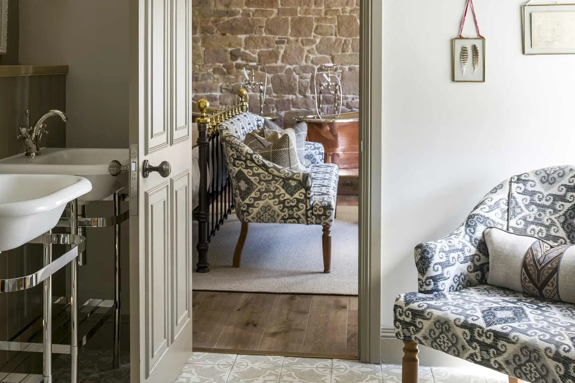 An open door revealing a chair and bathtub