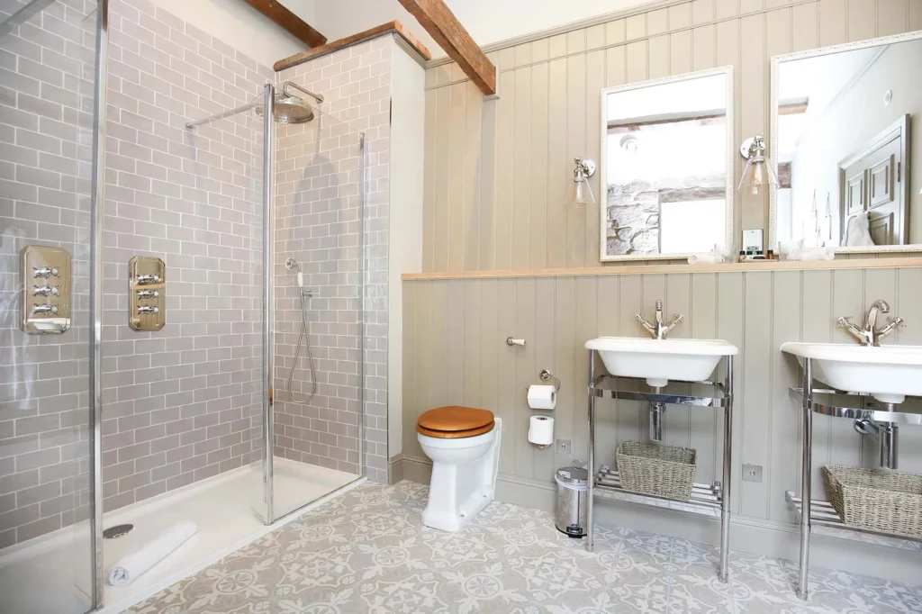 Bathroom with two sinks, toilet and shower